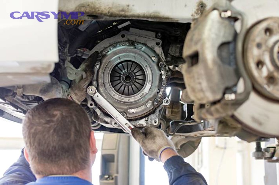 Mechanic working on clutch and pressure plate during clutch repair