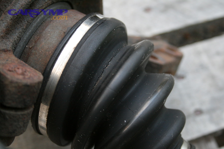 Close-up photo of a cracked CV boot showing visible cracking along the rubber folds
