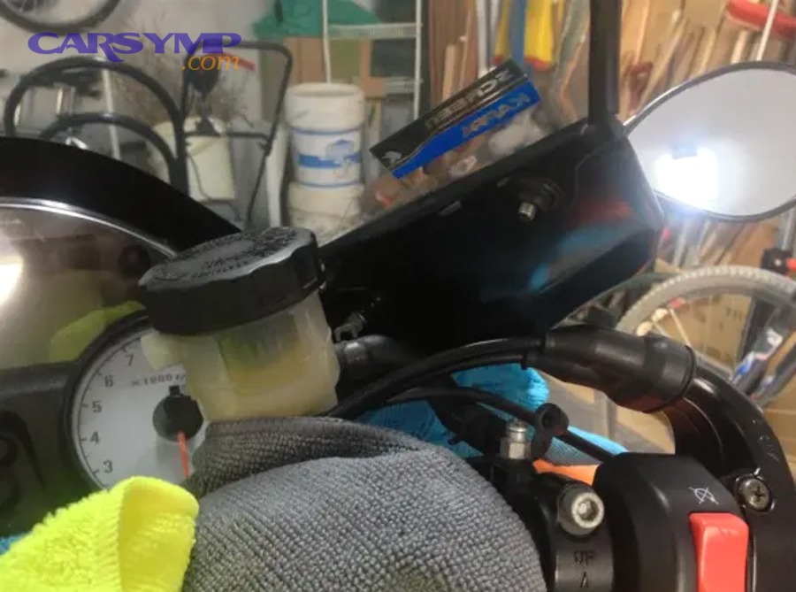 How do you confirm the correct brake fluid type before starting?