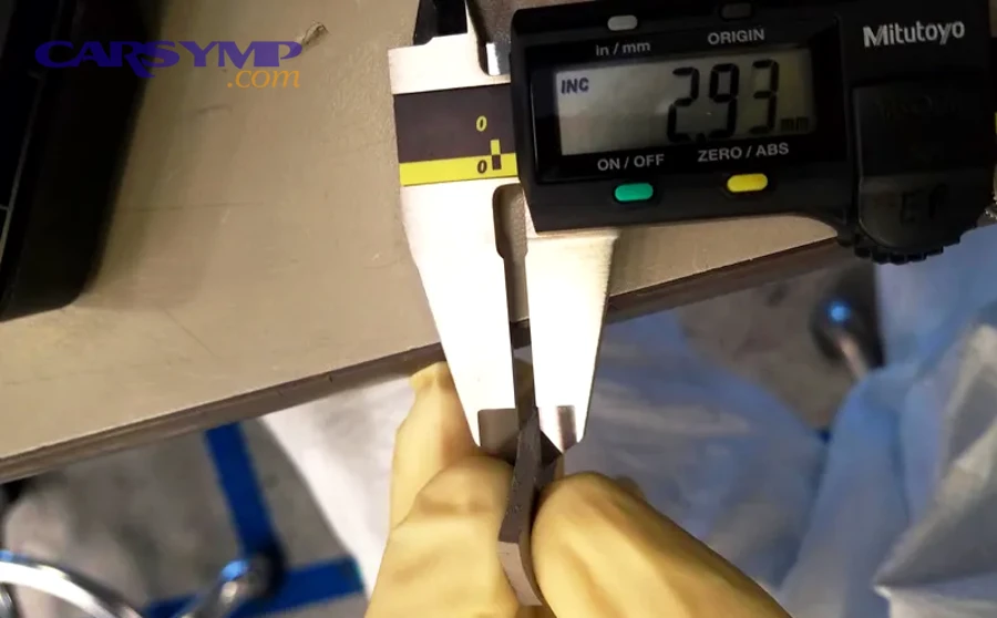 How do you measure pad thickness with the wheel off?