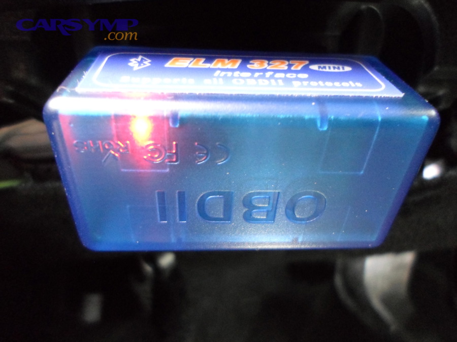 Bluetooth OBD2 scan tool (ELM327) plugged into a vehicle