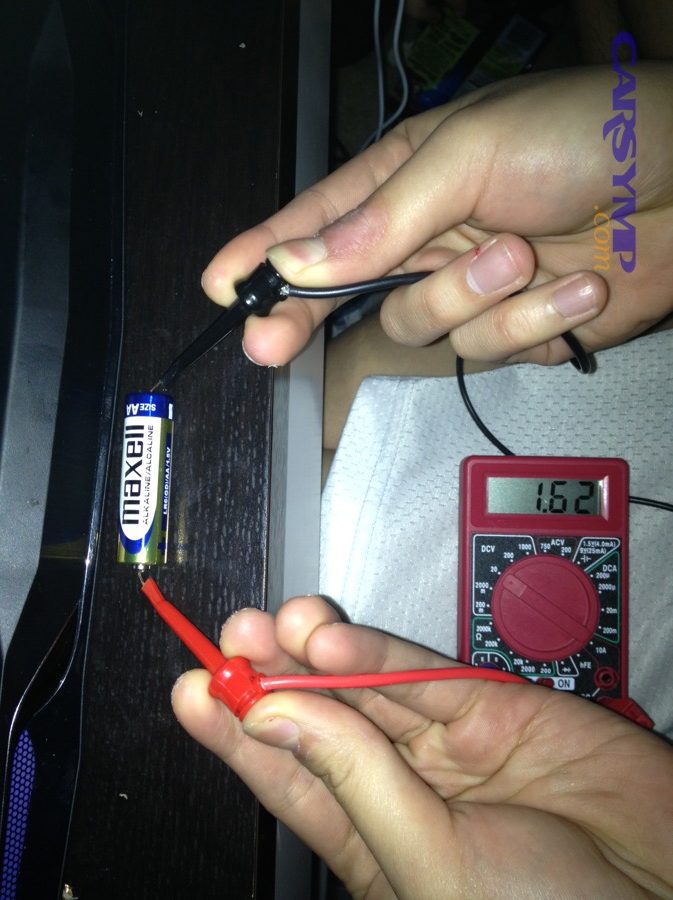Using a multimeter to test battery voltage with probes