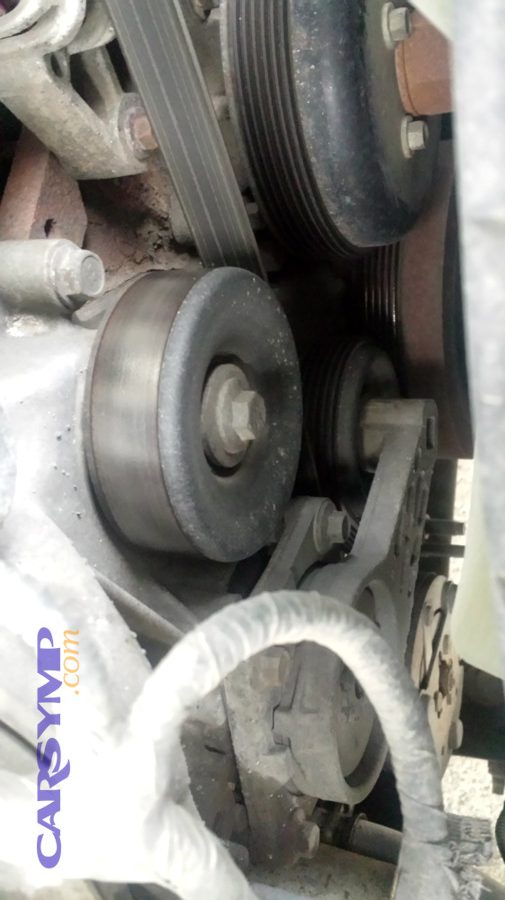 How do you test pulleys for bearing noise?