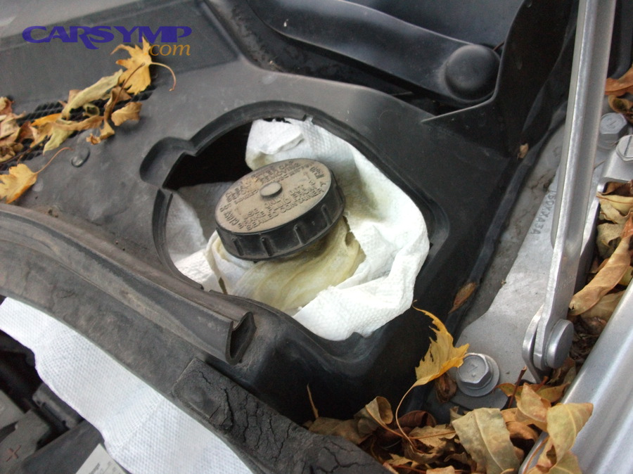 Why does old brake fluid cause a spongy pedal and longer stopping distances?