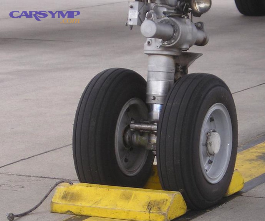 What is the safest surface and setup before you jack the vehicle?