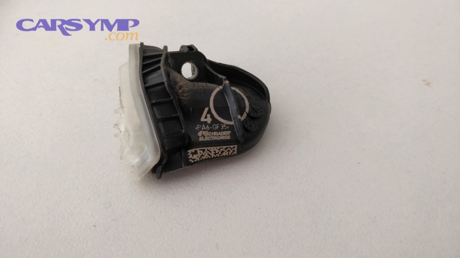 Damaged TPMS sensor removed from a wheel showing how sensor damage can trigger warning light