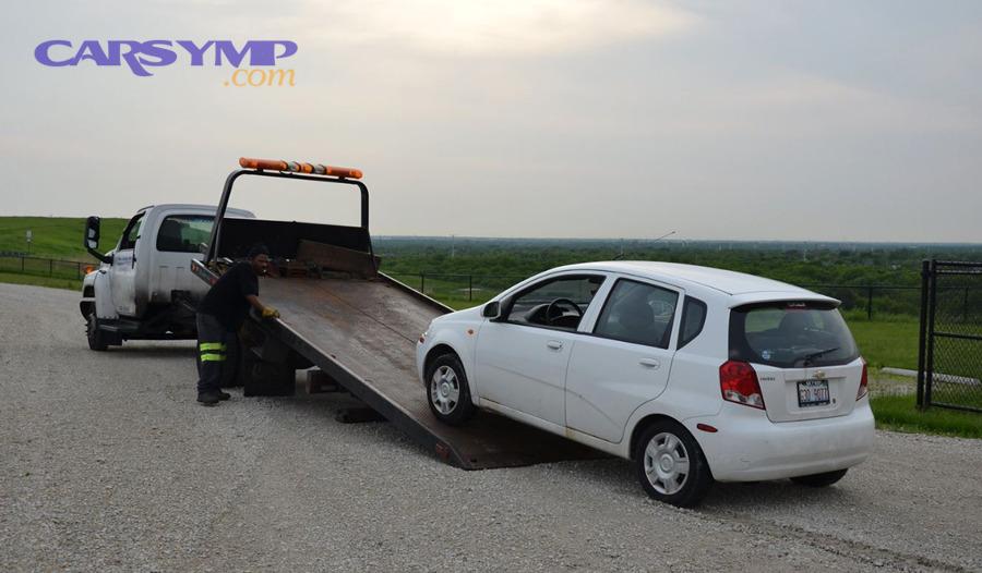 Flatbed Loading A White Car On A Flatbed Tow Truck Near Greenfield