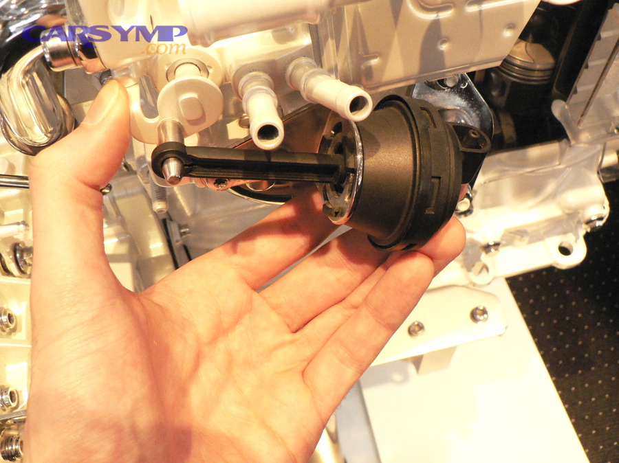 Vacuum-actuated EGR valve actuator example (vacuum canister controlling EGR valve movement)