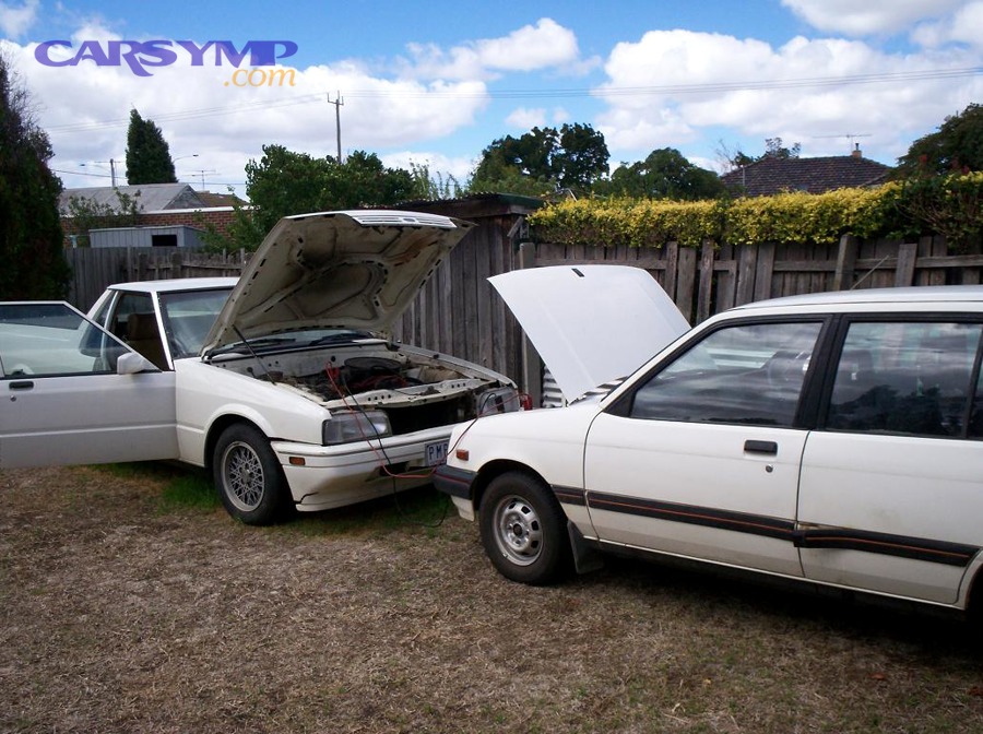 Jump starting a car with jumper cables between two vehicles