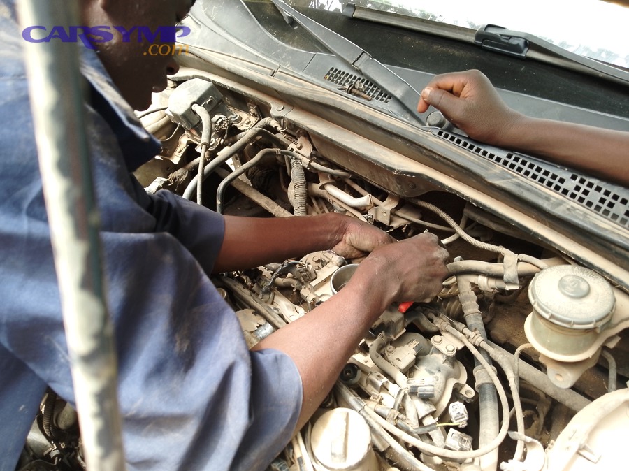 Mechanic repairing car engine 1