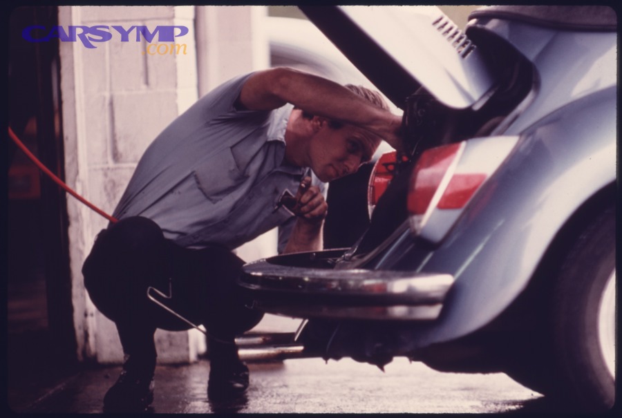 Mechanic working on a vehicle during an inspection at a service station