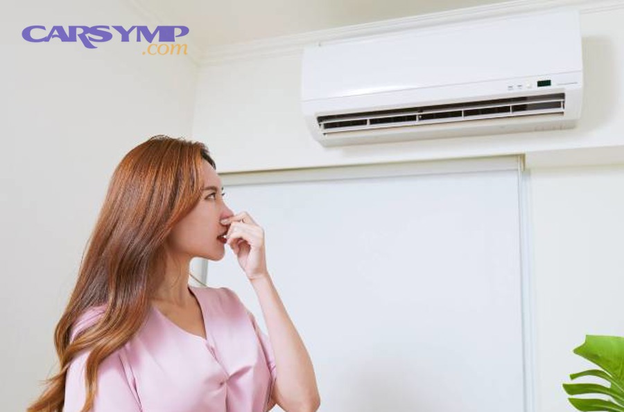 How do you unclog the AC drain line so odor and dampness stop returning?