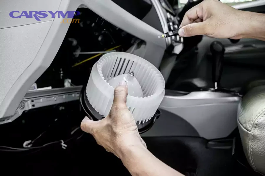 How do you access a blower motor behind the glove box?