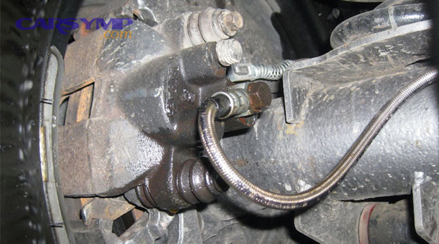 How can you spot brake hose failure during a quick driveway inspection?