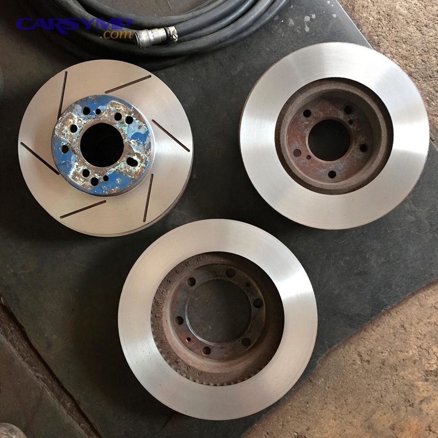 How do runout and hub problems change the resurface vs replace answer?
