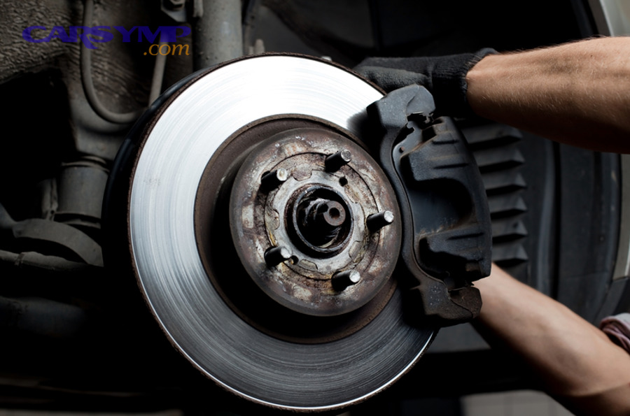 Why do brakes click, clunk, or rattle over bumps or at low speed?