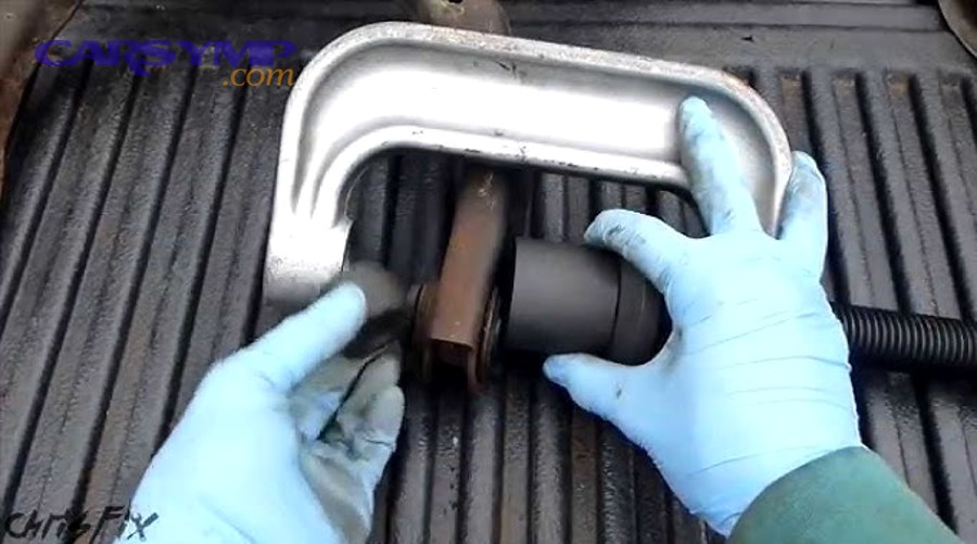 Lower control arm shown installed in a suspension layout with surrounding components