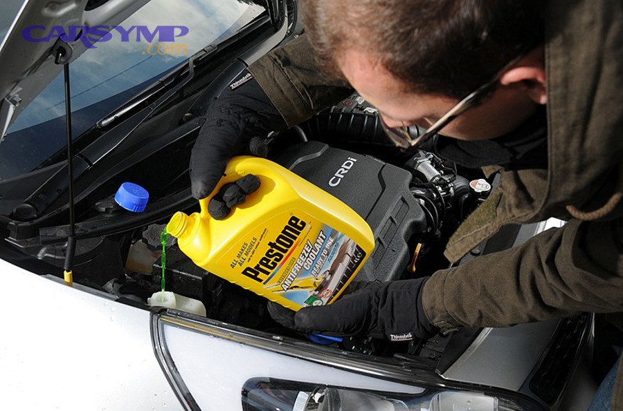 Coolant puddle under front of a car indicating a leak