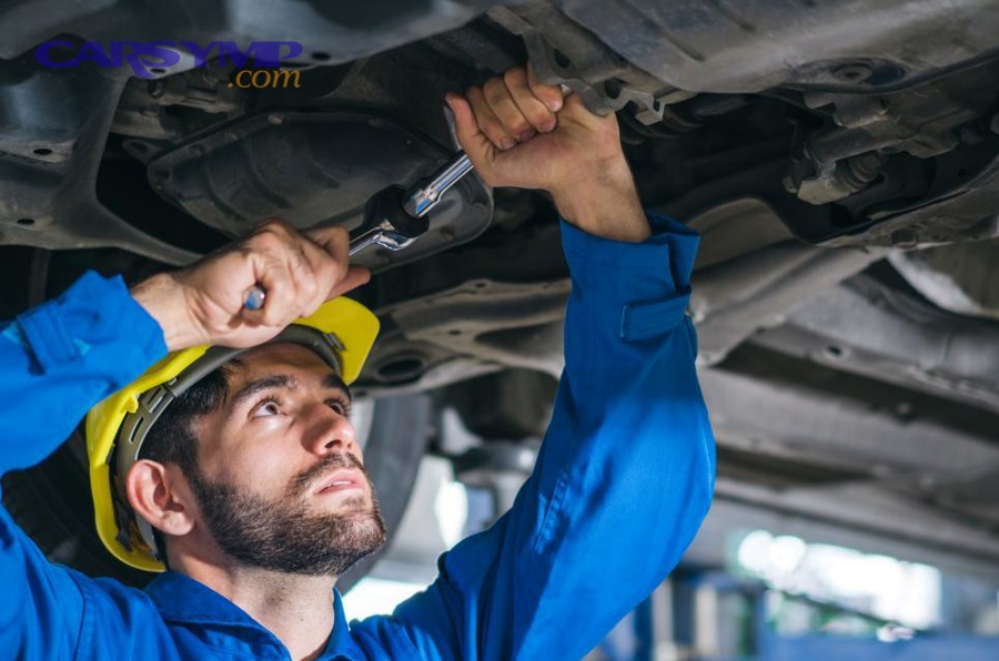 mechanic repairing car damage at auto shop