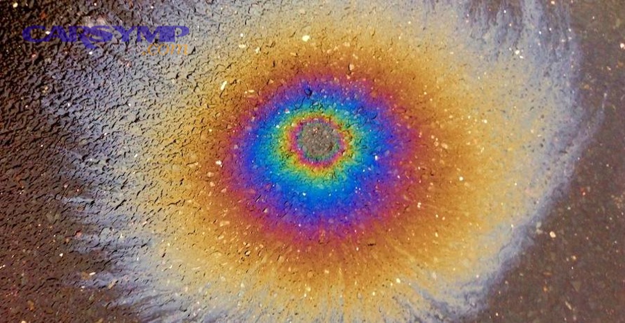 Which car fluids are most commonly confused with coolant based on puddle color?