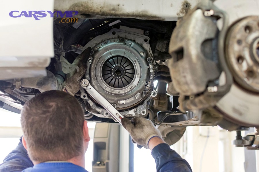 Manual transmission removed from vehicle for clutch replacement access