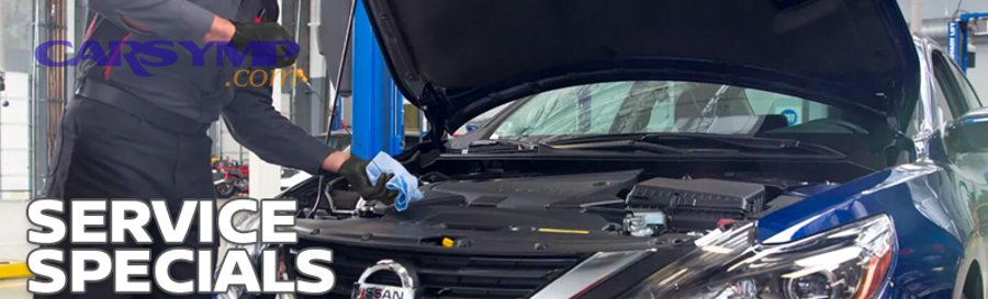 Technician performing electronic testing on a car battery and wiring