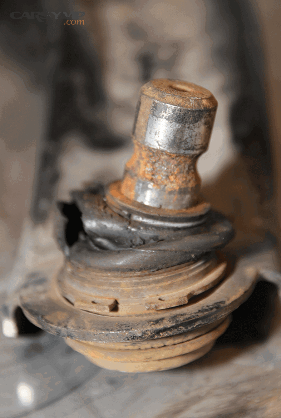 What visual and hands-on checks confirm ball joint wear safely?