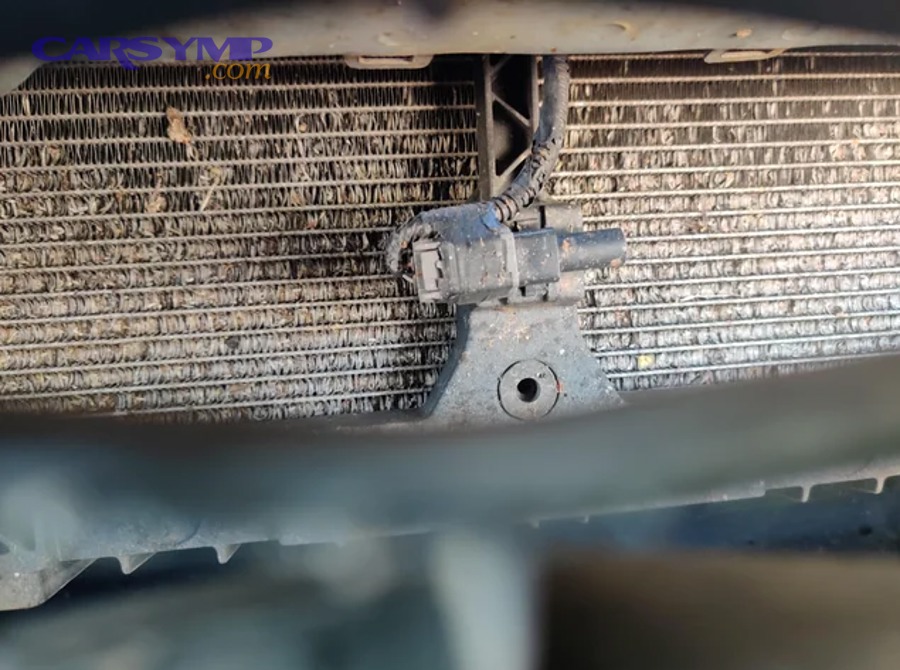 Close-up view of HVAC-style heat exchanger fins with sections bent, illustrating restricted airflow through fins