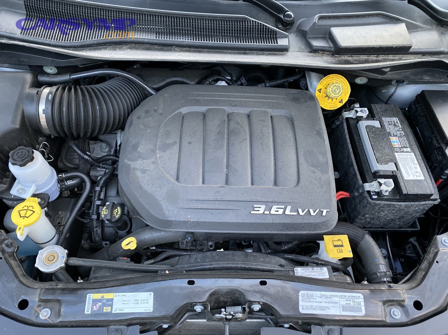 Modern car engine bay used to illustrate common external leak inspection areas