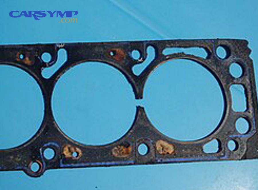 Damaged head gasket showing a leak path between cylinders