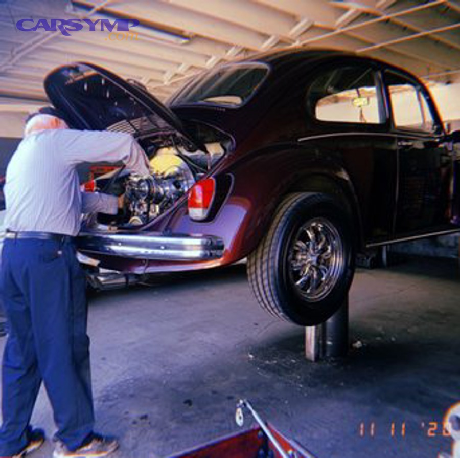 Technician working with advanced vehicle calibration and diagnostic equipment