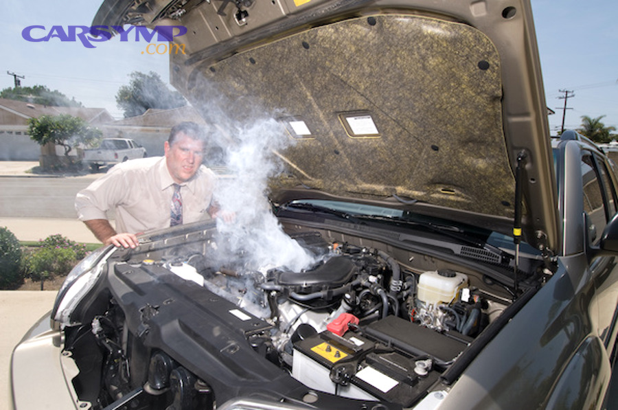 mechanic inspecting car coolant system for leaks