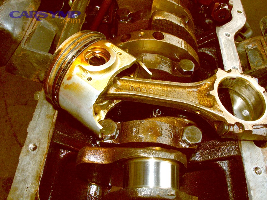 Piston and connecting rod removed from a disassembled engine block