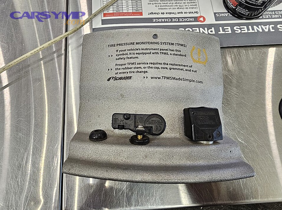 Direct TPMS sensors and components displayed on a work surface