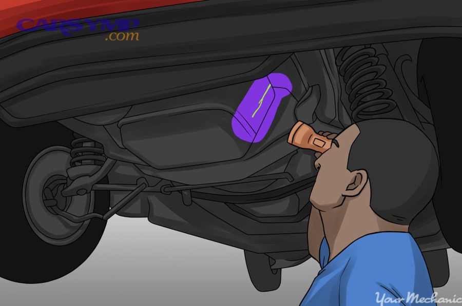 Using a UV flashlight to reveal a fluorescent oil leak trail