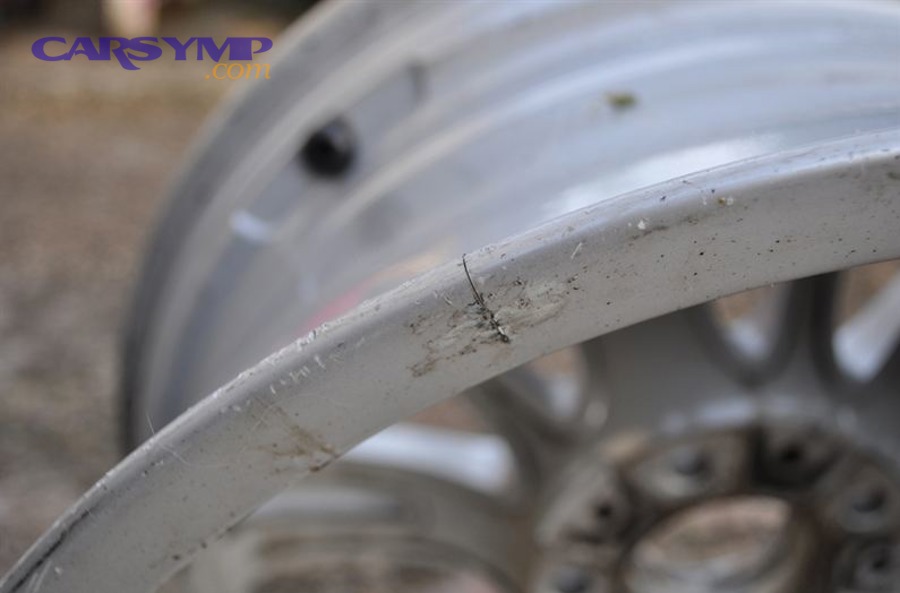 close-up of alloy wheel inspection showing crack detection process