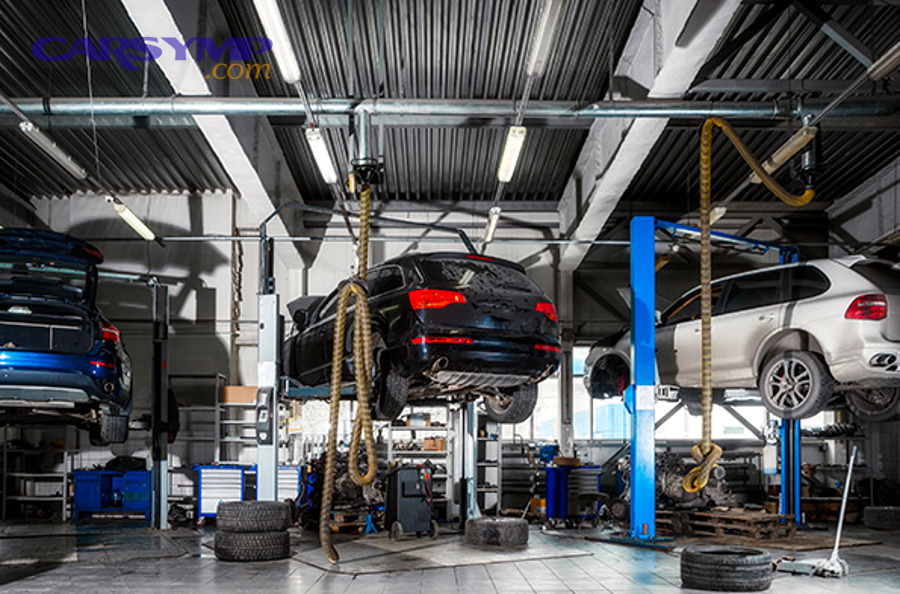 Professional mechanic with specialized suspension diagnostic equipment and tools