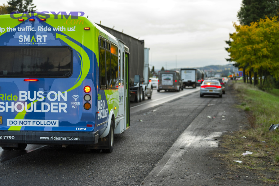 Vehicles traveling near a shoulder area, illustrating why visibility and hazard signals matter