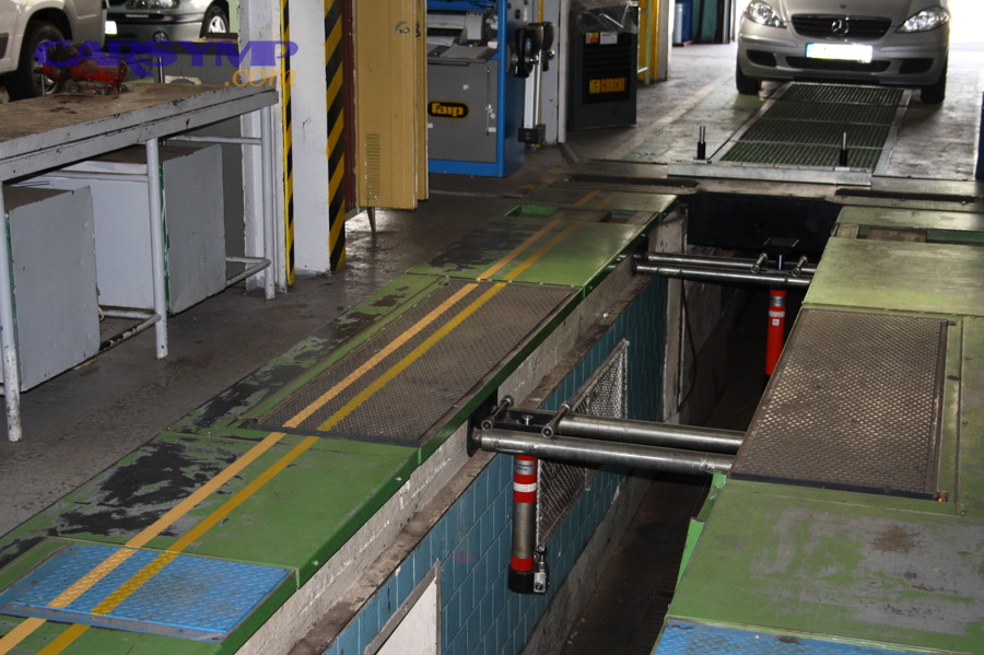 Automobile repair workshop with inspection channel and tools