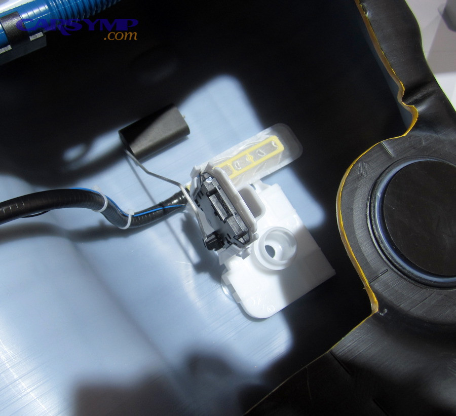 Inside an automobile fuel tank showing pump inlet and level sensor components