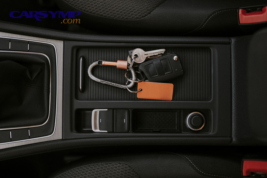 Car key placed in a vehicle center console area