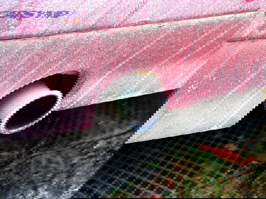 Car exhaust pipe visible under the rear of a vehicle