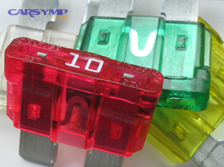 Close-up of blade-style car fuses showing amperage markings