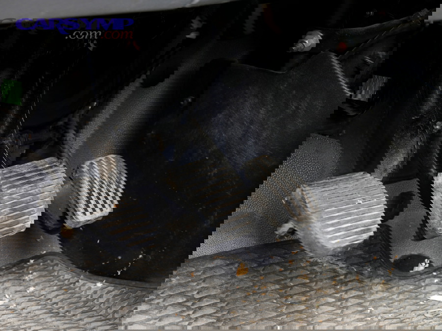 Car pedals showing clutch, brake pedal, and accelerator for driver reference