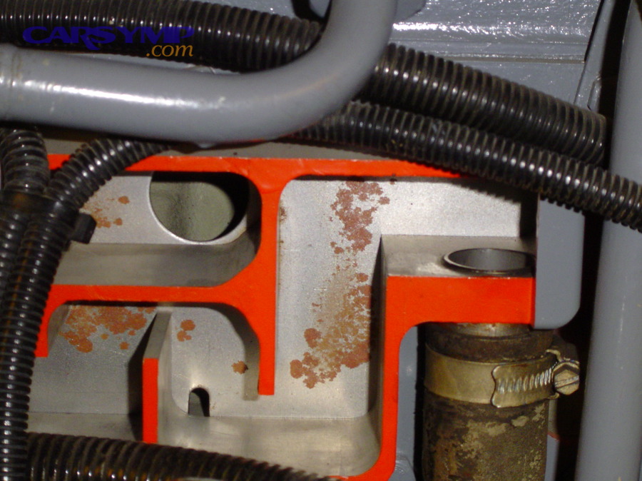Crankcase ventilation components on an engine, showing hoses and ventilation routing