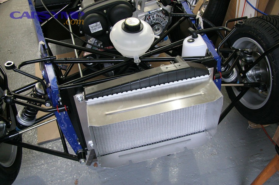 Coolant expansion tank (reservoir) in an engine bay near radiator components