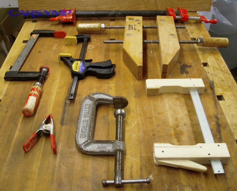 Various clamps on a workbench, representing common clamp types