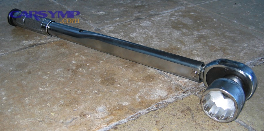 Click-style torque wrench with socket on floor