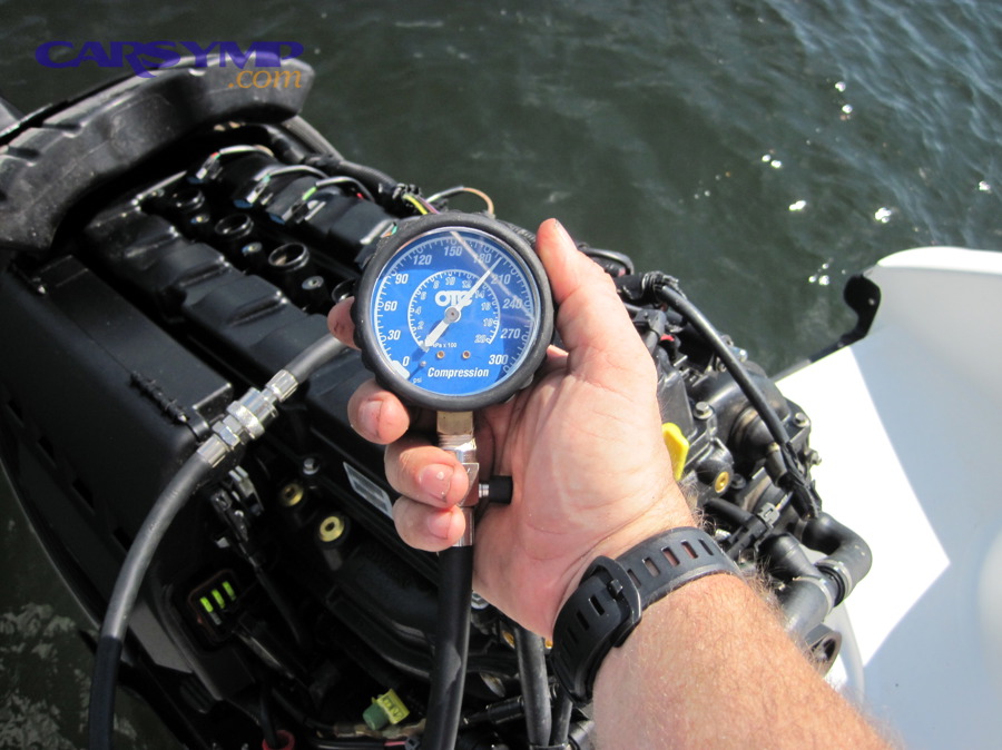 Compression gauge being used to test an engine