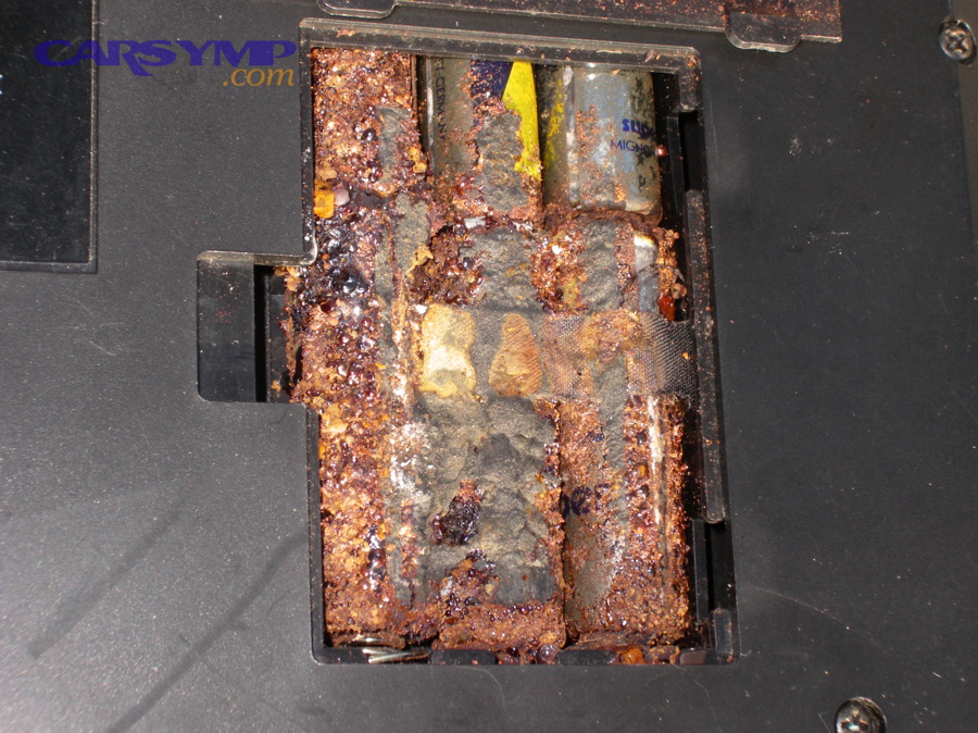 Multiple corroded batteries showing heavy terminal and case corrosion